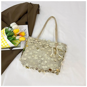 Golden sequin tote bag detail with pearl bow charm and elegant tulip styling