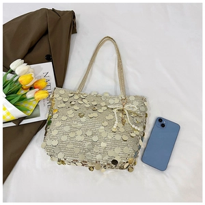 Golden sequin tote bag with pearl bow charm and tulips on white fabric background