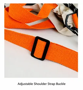 Close-up of bright orange canvas shoulder strap with black adjustable buckle and drawstrings