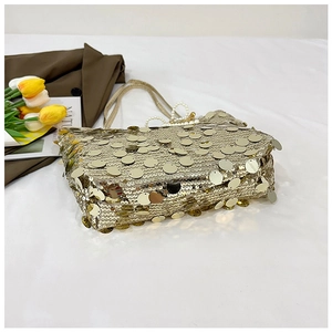 Detailed close-up of champagne gold sequin tote bag with elegant pearl beaded handle
