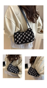 Detail of checkered tweed hobo bag featuring frayed edges and black leather strap