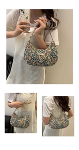 Detail of floral jacquard hobo bag with vintage flower patterns and gold metal logo plate