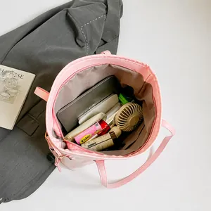 Interior view of pink plaid tote bag showing high capacity for tablets and cosmetics