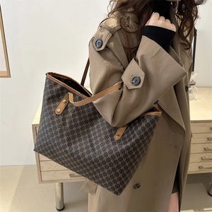Detail view of large retro tote bag with brown leather handles and vintage pattern