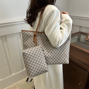 Detail view of large retro tote bag and matching pouch with classic monogram pattern