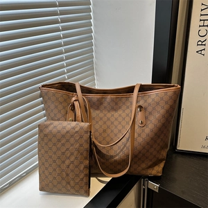 Detail view of large vintage monogram tote bag with matching inner pouch and brown trim