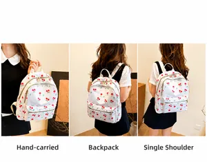 Détail du sac à dos blanc à imprimé cerise montrant les modes main, épaule et double sangle