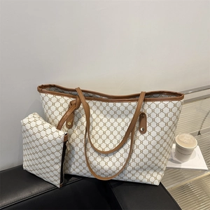 Detail of the large tote bag set with monogram pattern on a premium leather seat
