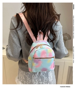 Detail of macaron tie-dye mini backpack featuring white star patterns and petal zipper pulls
