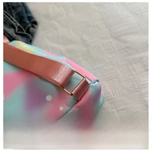 Close-up of pink and blue gradient backpack with durable nylon strap and gold metal buckles