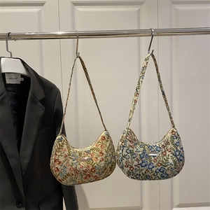 Floral tapestry hobo bags in orange and blue patterns with metallic logo and textile straps