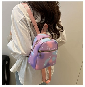Detail view of the mini dreamlike gradient backpack with heart patterns and flower zipper