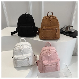 Detailed arrangement of mini corduroy backpacks in black brown white and pink colors