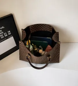 Top view of large retro tote bag interior showing ample storage for a tablet and umbrella