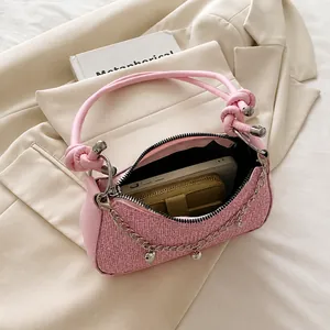 Top view of pink woven dumpling bag interior showing spacious capacity for phone and wallet