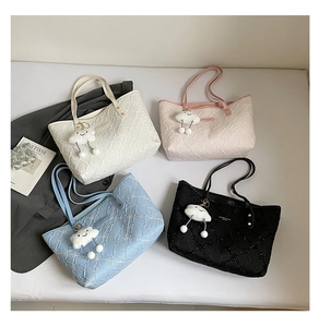 Close-up of quilted tote bags in four pastel colors with cute cloud charm accessories