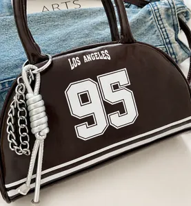 Detailed close-up of dark brown leather tote bag featuring Los Angeles 95 white lettering