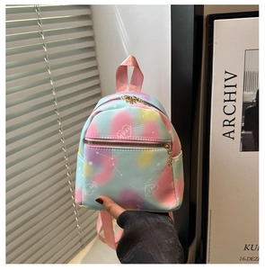 Detail of macaron-colored mini backpack with heart print and gold zipper detail