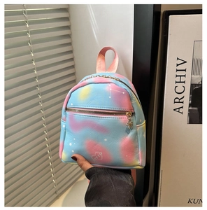 Detail of floral zipper pulls and star patterns on gradient mini backpack