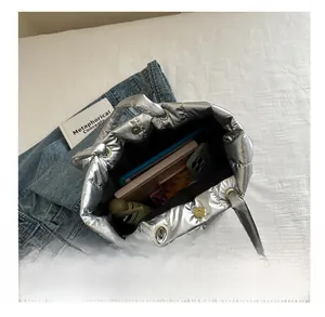 Macro view of silver padded tote bag showing large capacity and magnetic metal closure