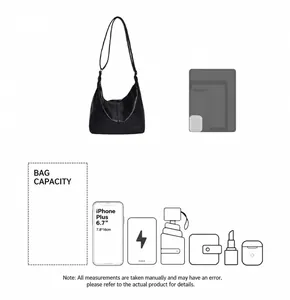 Detail showing the large capacity of this black tote bag fitting a tablet and umbrella
