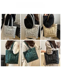 Quilted down tote bags in silver, gold, and green shown on model for various outfits