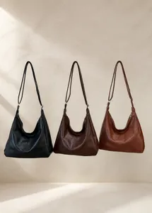 Detailed display of three hobo shoulder bags in black, dark brown, and caramel colors