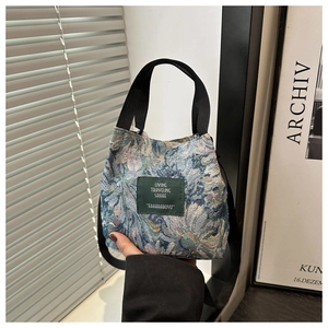 Floral canvas bucket bag with grey-blue flowers and adjustable crossbody strap
