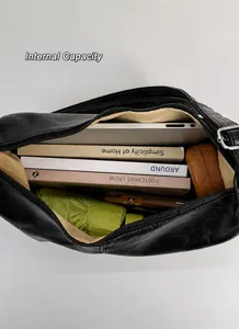 Interior view of large black commuter tote bag showing spacious beige lining and capacity