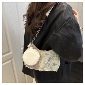 Dettaglio della borsa a stella patchwork in denim con frange e catena argento