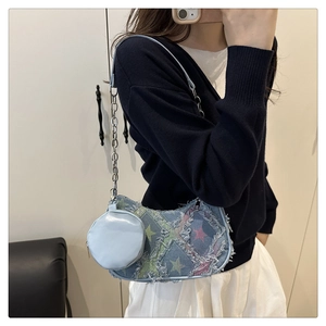 Detail view of denim star-pattern shoulder bag with silver chain and coin purse