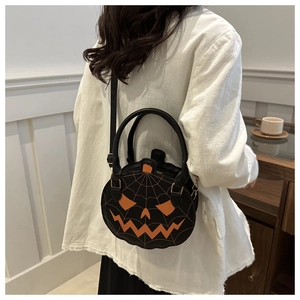 Rear view of model wearing a black Halloween pumpkin crossbody bag with spider web stitching