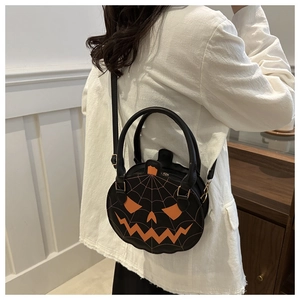 Detail of a Halloween pumpkin crossbody bag with spider web texture and orange facial patch