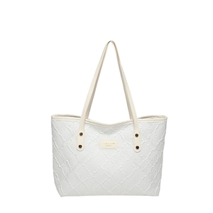 Large capacity white quilted tote bag with embossed pattern and metal rivets