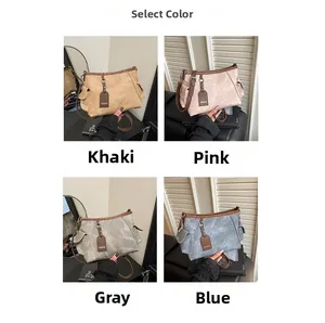 Detail view of solid color distressed leather shoulder bags in khaki, pink, grey, and blue