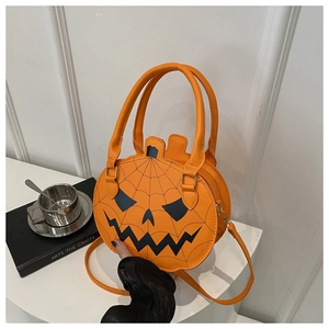Detailed view of pumpkin-shaped crossbody bag with festive spider web and jack-o-lantern face