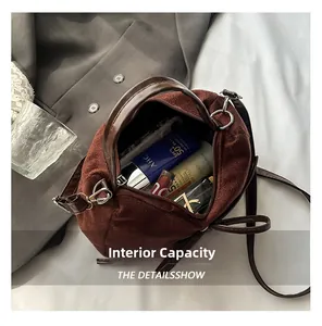 Internal view of the brown suede handbag showing spacious storage for cosmetics
