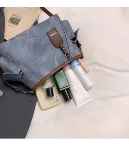 Interior view showing the large capacity of a blue canvas crossbody bag for essentials
