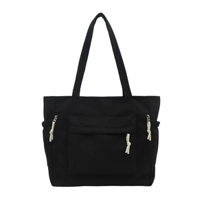 Stylish black multi-pocket tote bag with large capacity and contrasting white zipper pulls