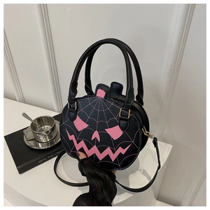 Detail view of black leather pumpkin bag featuring pink spider web print and sturdy handles