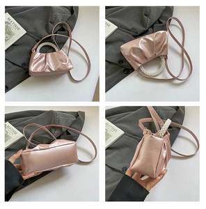 Detailed views of a pink pleated mini bag with pearl handle and detachable strap
