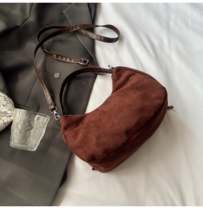Detail of the brown corduroy tote bag showing its soft texture and brown leather strap