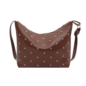 Dark brown punk style crescent shoulder bag with silver studs and adjustable strap