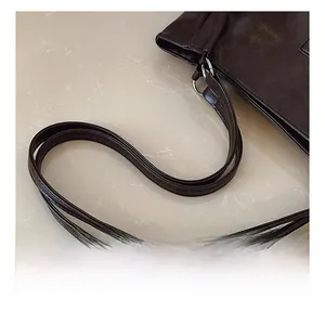 Close-up of comfortable leather handle and silver metal ring on large coffee tote bag
