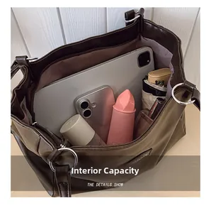 Detail view of large capacity vintage tote bag interior with tablet and daily essentials