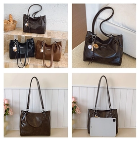 Detail view of large capacity faux leather tote bag in coffee, black and caramel colors