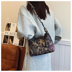 Detail view of floral print crossbody bag with adjustable strap and vintage flower pattern