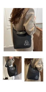 Ricamo dettagliato di un cane bianco minimalista su una borsa tote in tela nera