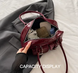 Interior view showing large capacity of the burgundy patent leather shoulder bag