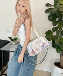 Detailed view of silver Ita bag with clear window and metallic PU leather finish